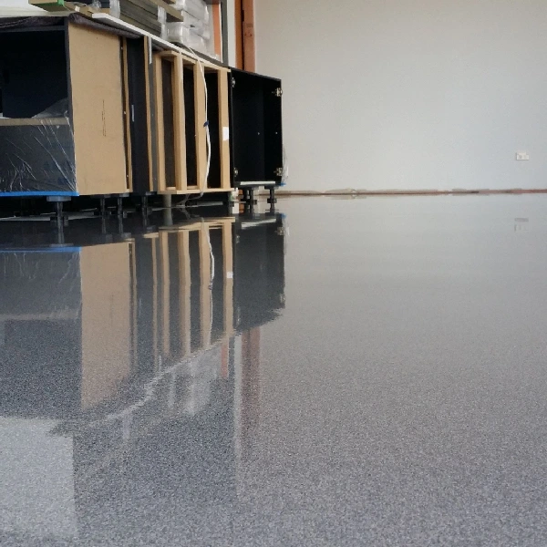 gray speckled concrete epoxy flooring with a glossy finish